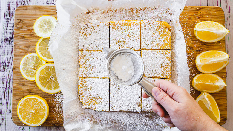 putting powdered sugar on squares