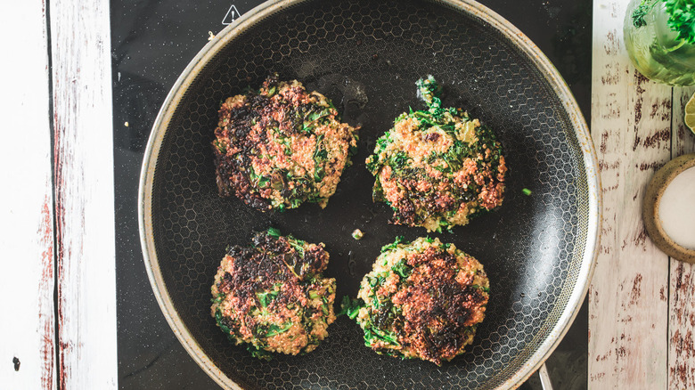 quinoa cakes frying in pan