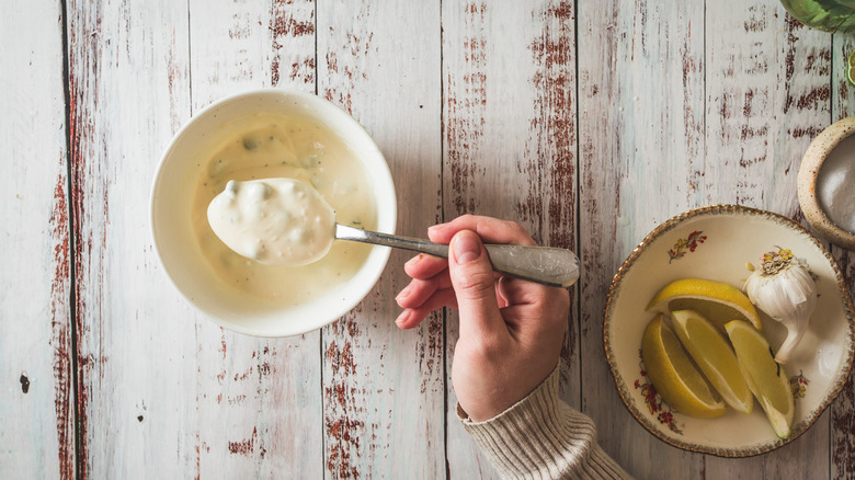 mixing tartar sauce in bowl