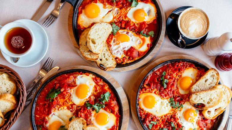 stew with fried eggs and bread