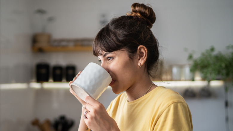 Young woman drinking a cup of coffee