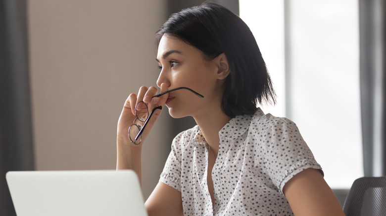 Woman sitting anxiously at her computer