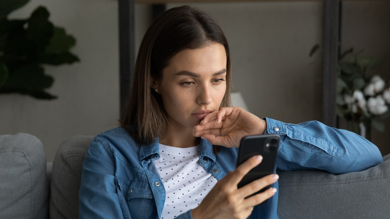 Woman anxiously reading the news