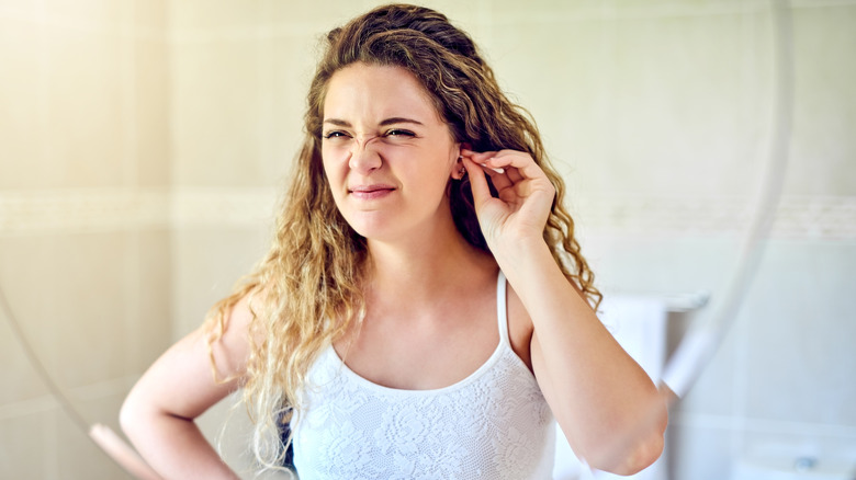 Woman tugging at her ear