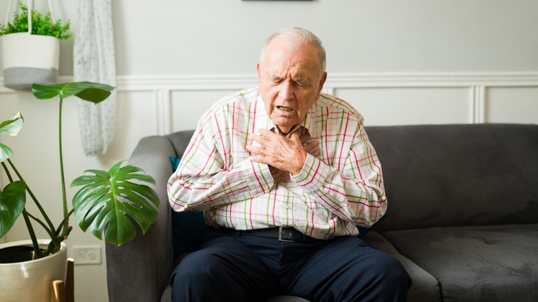 Senior man having trouble breathing