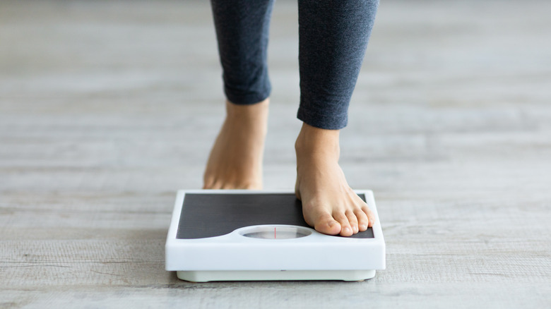 person standing on scales