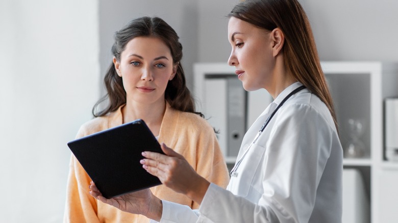 young woman talking to her doctor