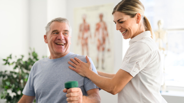 Man doing physical therapy exercises with therapist