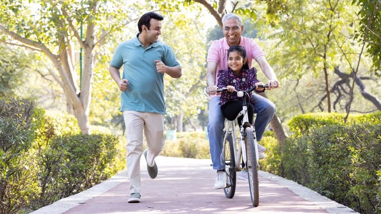 family running and biking together