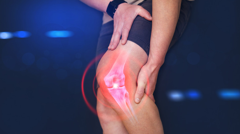 person holding knee in pain