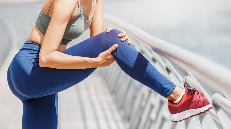 woman holding knee