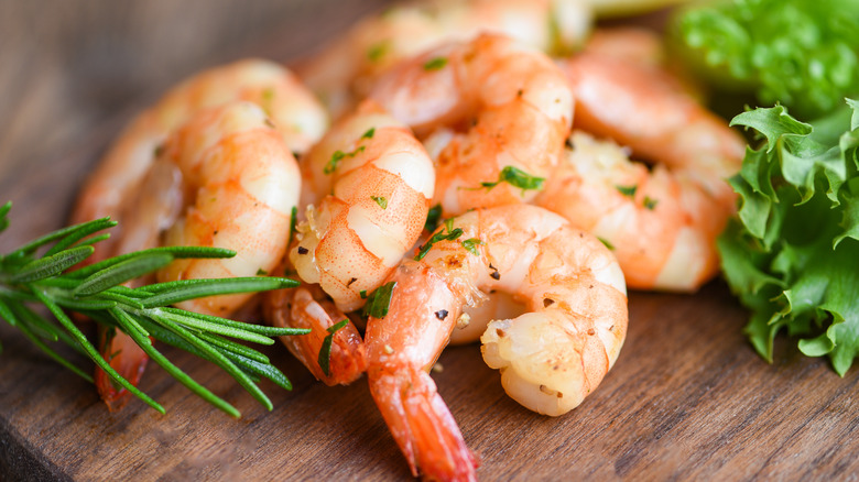 cooked shrimp on wooden board