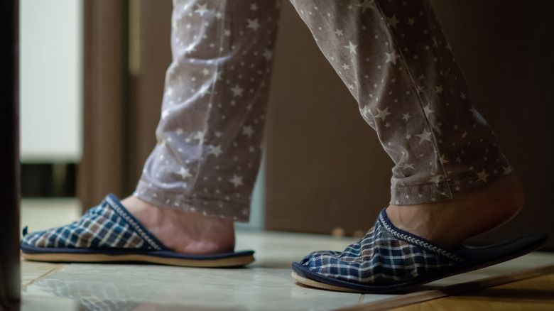 woman in pyjamas walking at night