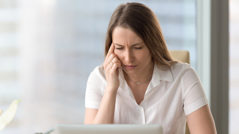 woman squinting at screen