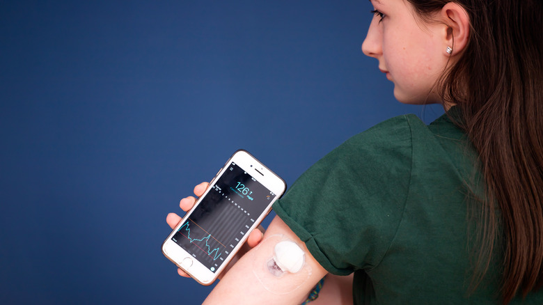 girl checking blood glucose