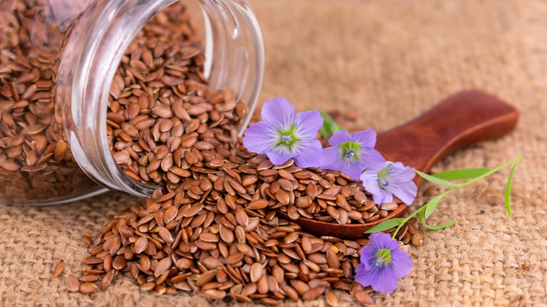 Flax seeds spilling out of jar