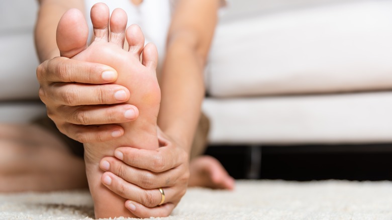 person holding sole of foot