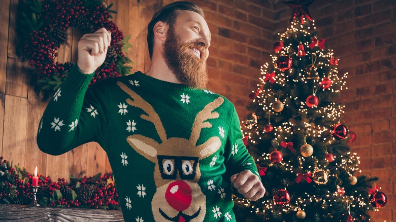 man with Christmas jumper dancing 