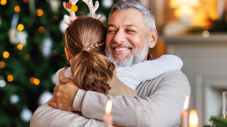 man hugs girl at Christmas