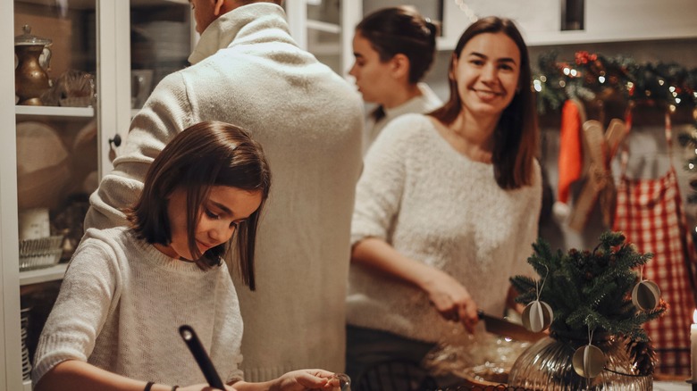 woman with family helping in kitchen