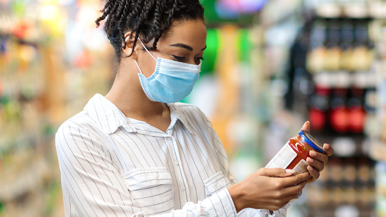 woman looking at food label