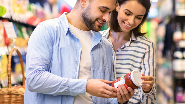 couple looking at jar of food