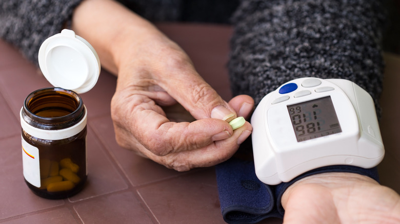 Person holding tablet while getting blood pressure