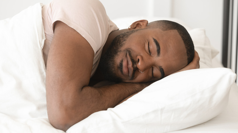 man sleeping peacefully in bed