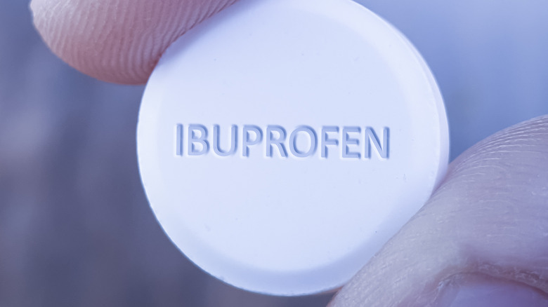 person holding ibuprofen close-up