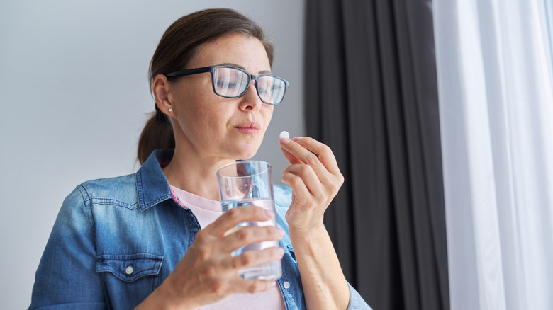 woman taking supplement