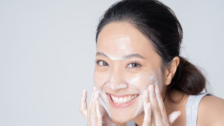 woman exfoliating face