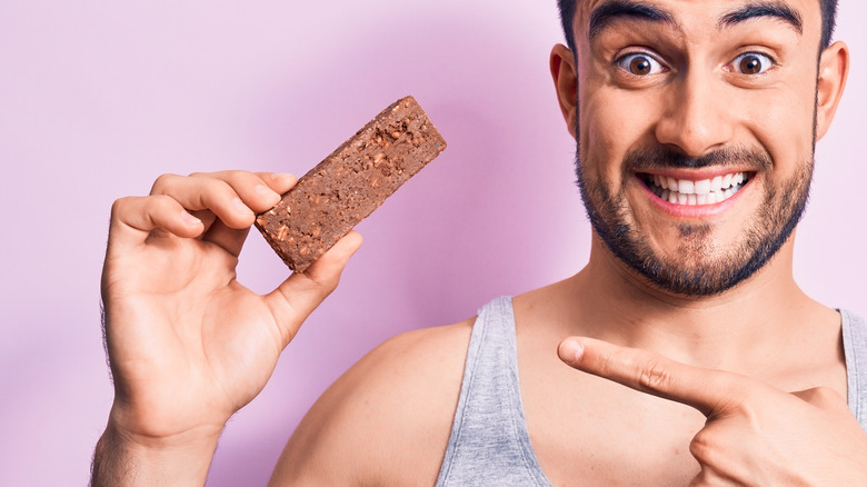 man holding energy bar