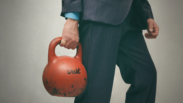 Worker holding kettlebell in one hand