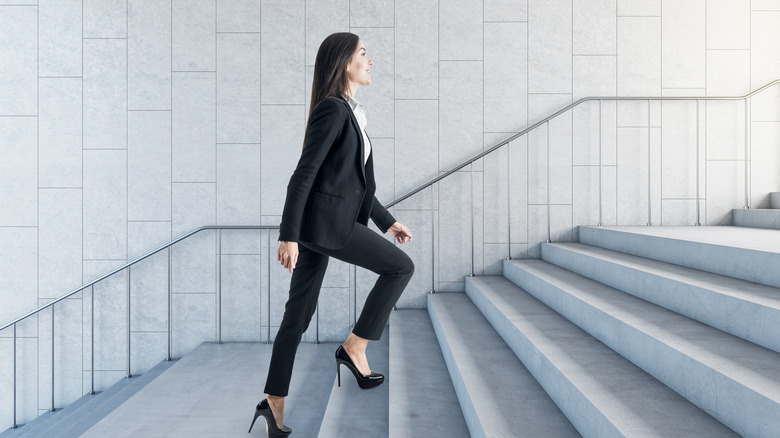 Woman stepping up a flight of stairs