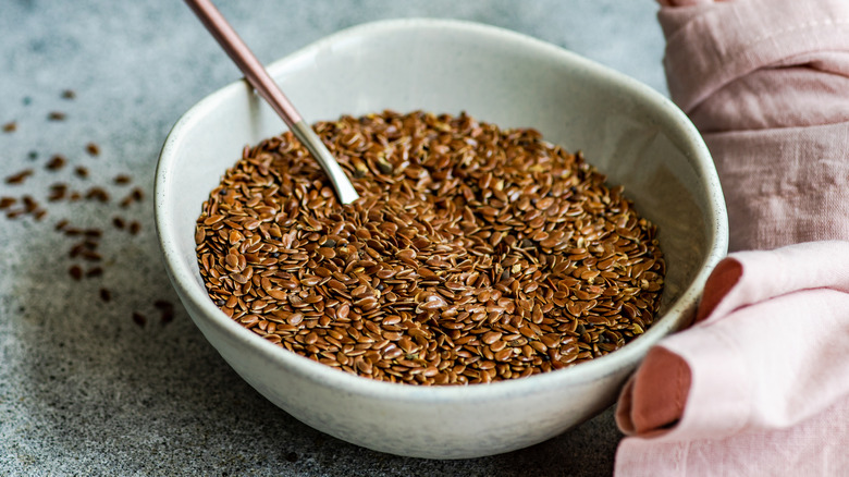 Bowl of flaxseed next to pink apron