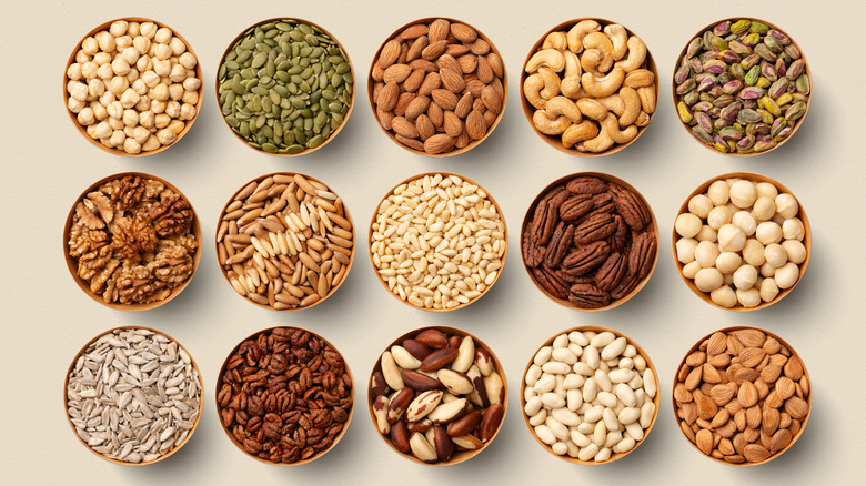 Top view of different nuts in separate bowls