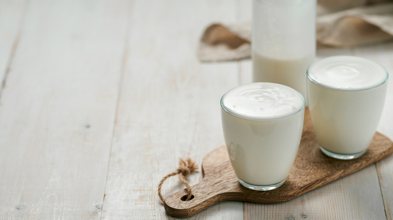 glasses of yogurt on wooden board