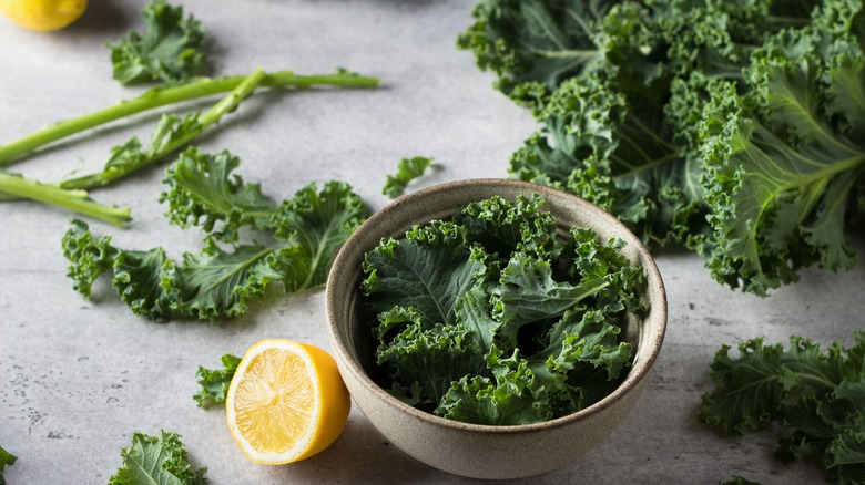 cut kale in bowl and counter top with lemon