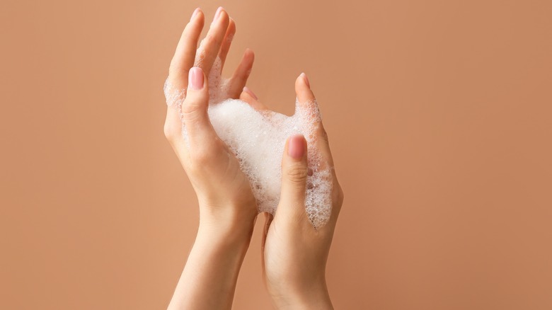 person with soap on hands