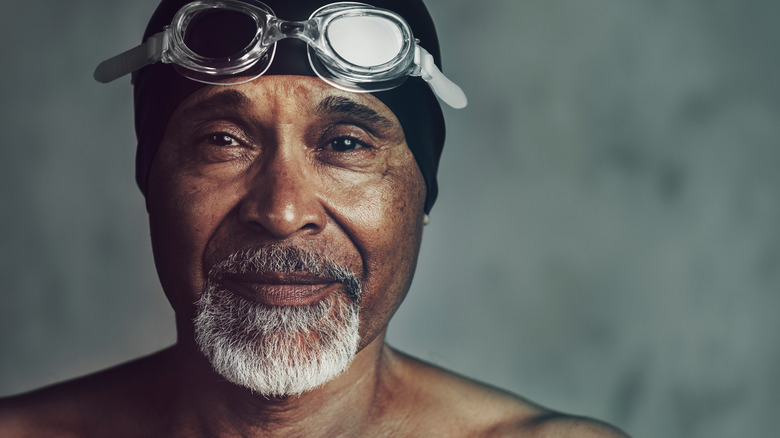 older man with swimming goggles