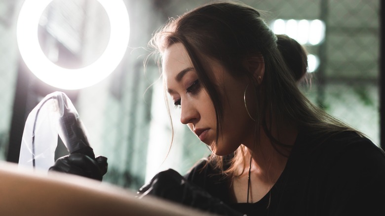 woman tattooing