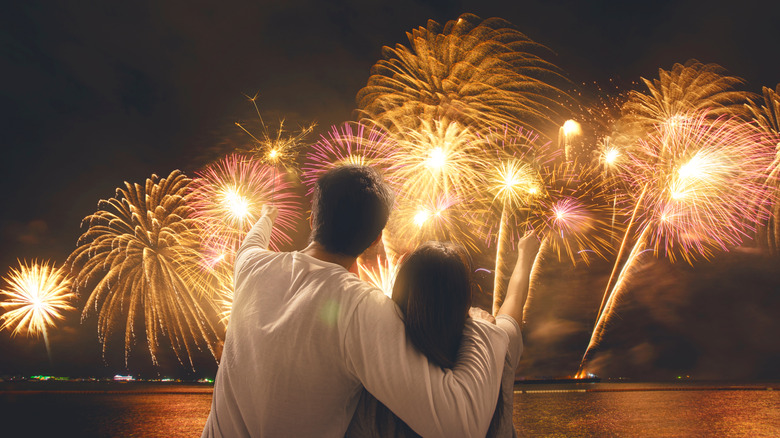 Two people watching fireworks