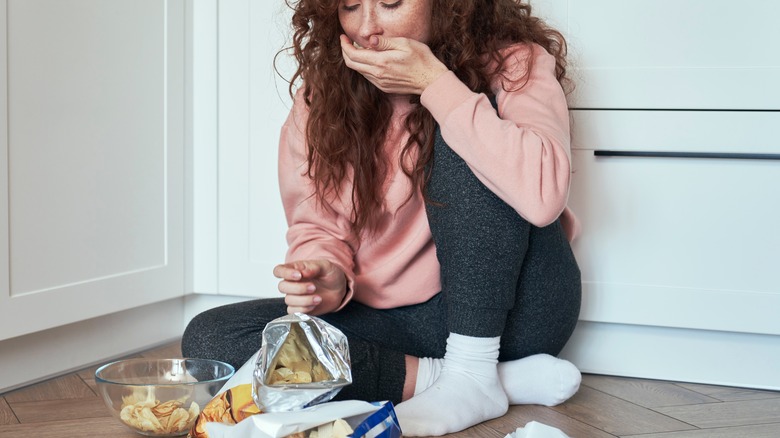 woman binging on unhealthy food