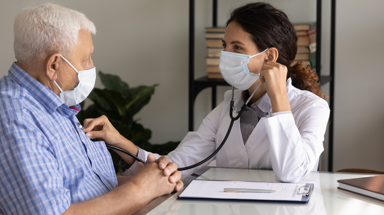 doctor with stethoscope and patient