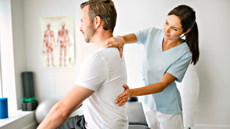 chiropractor performing an adjustment on back