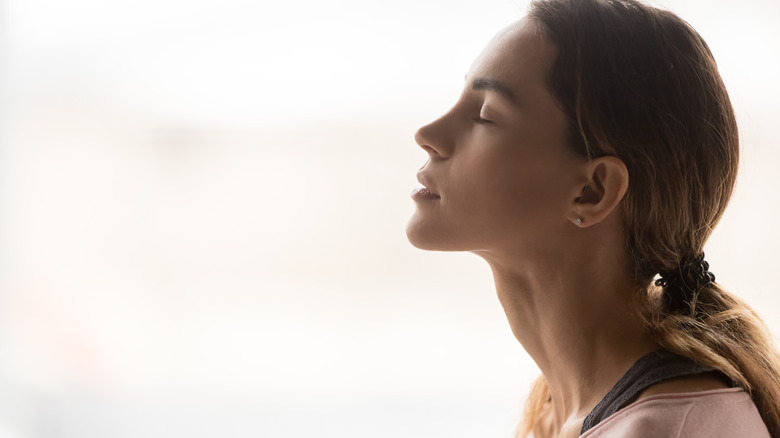 profile of woman meditating with eyes closed