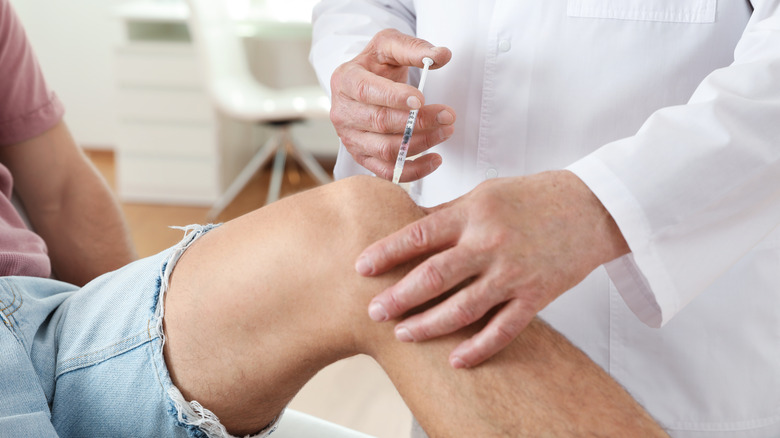 doctor injecting knee with anesthetic