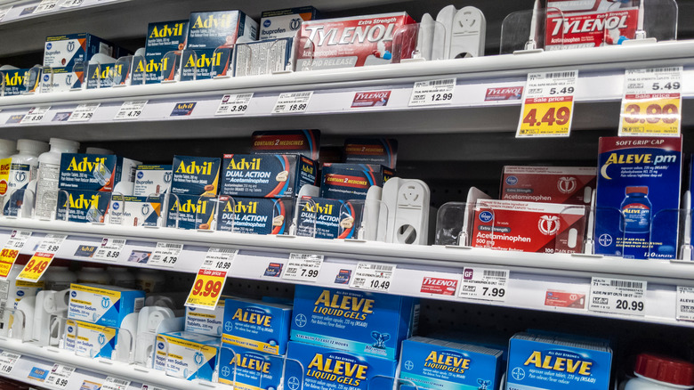 store shelves stocked with tylenol, advil, aleve