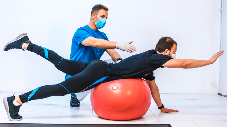 physical therapist with patient doing exercises 