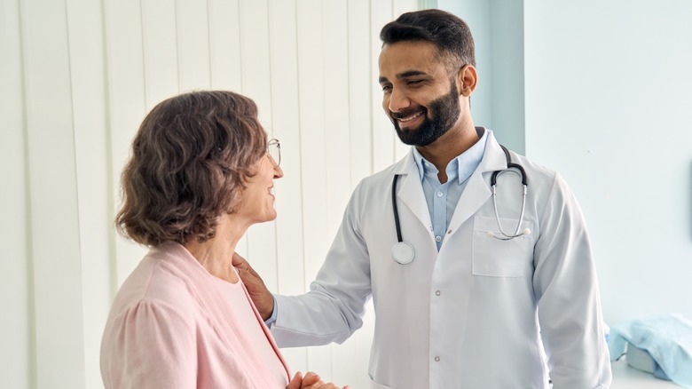 woman and male doctor smiling at each other
